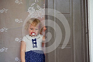 upset little girl at the door,emotions of a child saying goodbye at the door