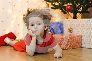 Upset little girl waiting for a surprise. no christmas gifts for baby.