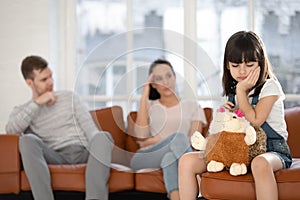 Sad little girl suffer from parents fighting at home photo