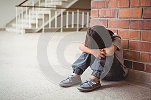 Upset lonely child sitting by himself