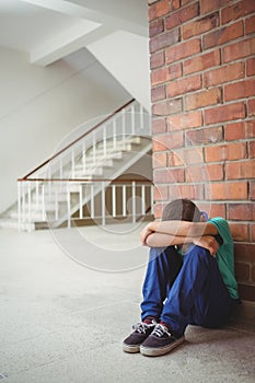 Upset lonely child sitting by himself