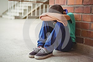 Upset lonely child sitting by himself