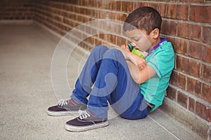 Upset lonely child sitting by himself photo