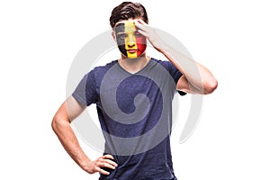 Upset loser fan support of Belgium national team with painted face isolated on white background