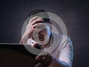 Upset Man Crying When Looking at Laptop