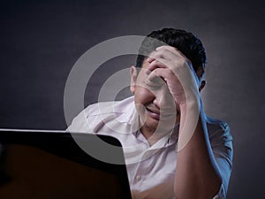 Upset Man Crying When Looking at Laptop