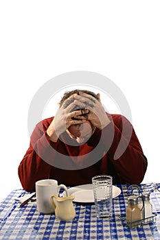 Upset man at diner with hands in mussed hair