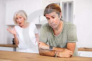Upset man dont speaking after discord with aged wife behind