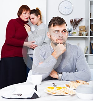 Upset man having problems in relationship with family