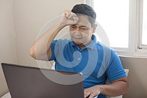 Upset Man Looking at Laptop