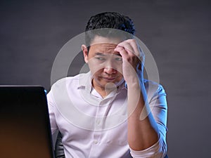 Upset Man Looking at Laptop