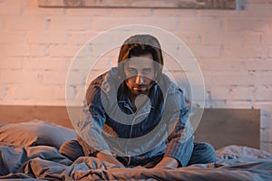 Upset man in pajama looking at