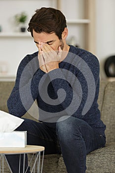 Upset man on sofa