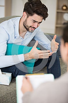 upset man talking to therapist