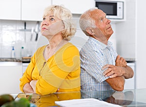 Upset mature couple discussing, quarrel at home interior