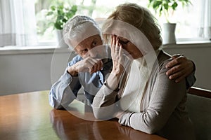 Upset middle aged family couple getting bad news photo