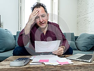 Upset middle aged man stressed about credit card debts and payments not happy accounting finances