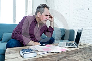 Upset middle aged man stressed about credit card debts and payments not happy accounting finances