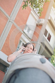 Upset mother talking on mobile phone