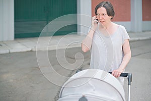 Upset mother talking on mobile phone