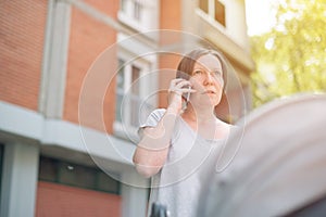 Upset mother talking on mobile phone