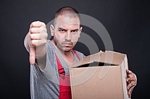 Upset mover man holding box showing thumb down