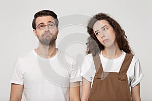 Upset not concentrated exhausted millennial couple feeling bored.