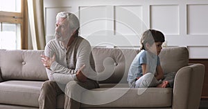 Upset old grandpa and kid grandson having generations conflict concept