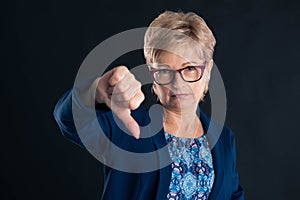 Upset older secretary showing dislike sign