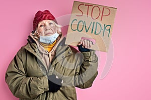upset poor homeless woman in dirty wear wants coronavirus to be stopped