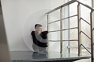 Upset preteen boy sitting on staircase