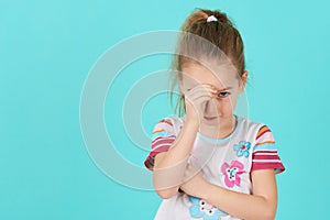 Upset problem child with head in hands. Bullying, depression, stress or frustration concept. Angry little girl.