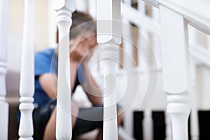 Upset problem child sitting on stairs