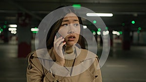 Upset sad Asian woman chinese korean japanese businesswoman talking mobile phone alone in car parking call taxi