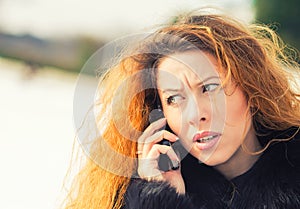 Upset sad, skeptical, unhappy, serious woman talking on phone