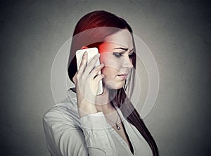 Upset sad woman talking on mobile phone. Cellular mobile radiation concept