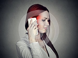 Upset sad woman talking on mobile phone. Cellular mobile radiation concept photo