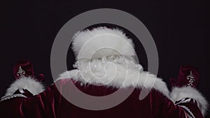 Upset santa claus banging his head on a black wall