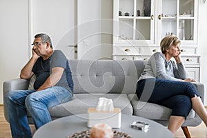 Upset senior couple at home having an argument