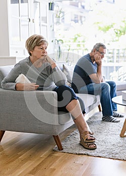 Upset senior couple at home having an argument