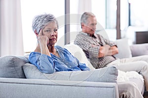 Upset senior couple ignoring each other