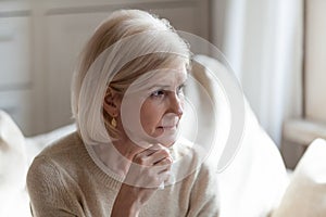 Upset senior woman sorrow for something at home