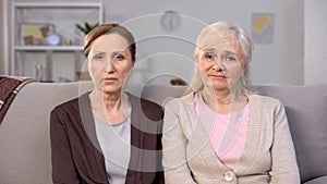 Upset senior women looking camera, social insecurity, pension reform, crisis photo