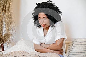 upset sick african american woman feeling acute stomach pain