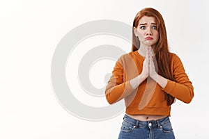 Upset silly cute redhead girlfriend grimacing upset hold palms together pray begging favour asking pleading help