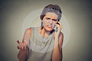 Upset skeptical, unhappy angry woman talking on phone