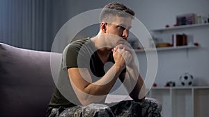 Upset soldier remembering terrifying war, suffering ptsd, psychological help photo