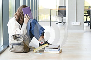 Upset teen girl sit on floor sadly look out window worried about teenage problem at school and communication with parent