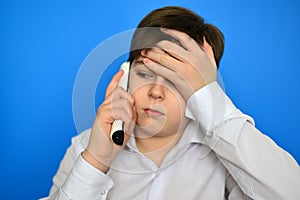 Upset teenage boy talking by radiotelephony