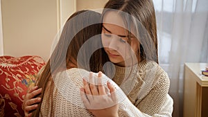 Upset teenage girl crying at her friends shoulder. Friends support and teenager depression